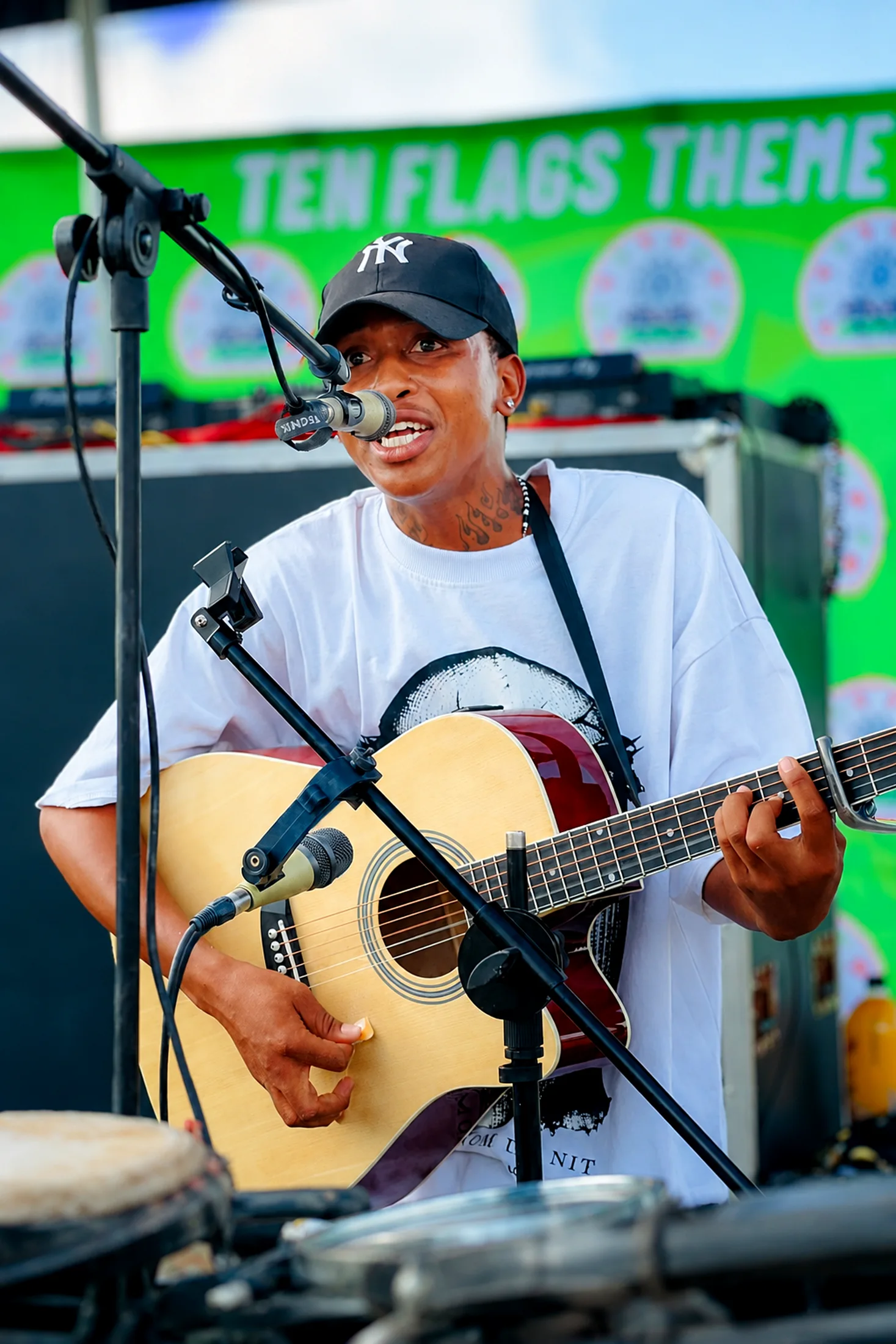 Outdoor festival performance with bright backdrop